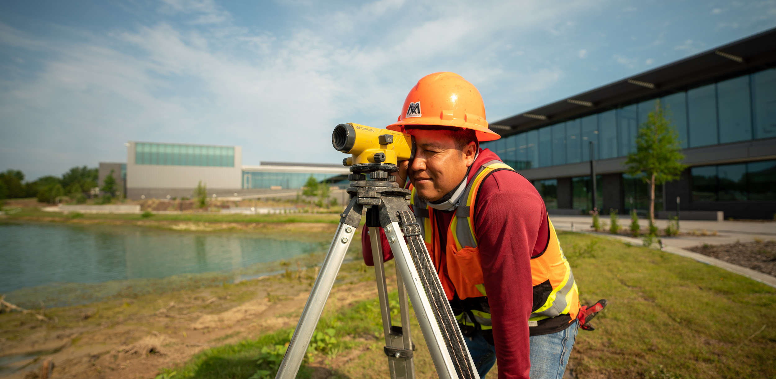 man surveying land with his equipment